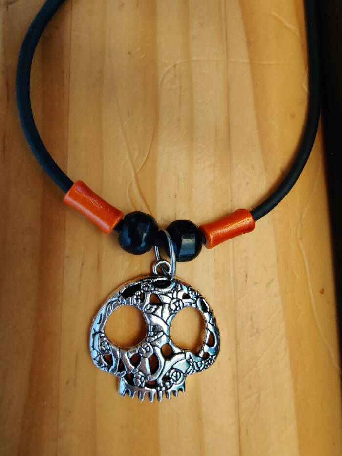 HN #10 Calavera (Skull) Black Rubber Cord 18-1/2 inch18-1/2 inch . Orange Tube Glass Beads, Black 6mm Wood. Lobster Closure